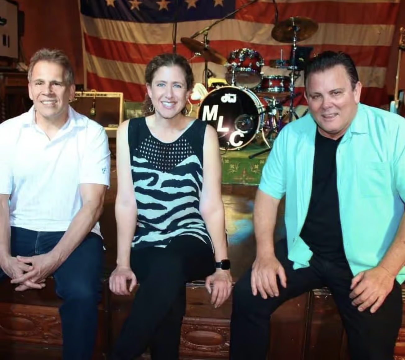 Live music band MLC sitting on the front of the stage